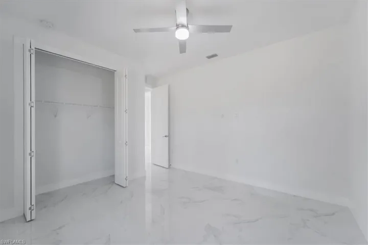 Unfurnished bedroom featuring a closet and ceiling fan
