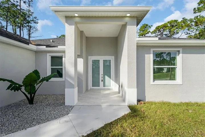 Property entrance featuring french doors
