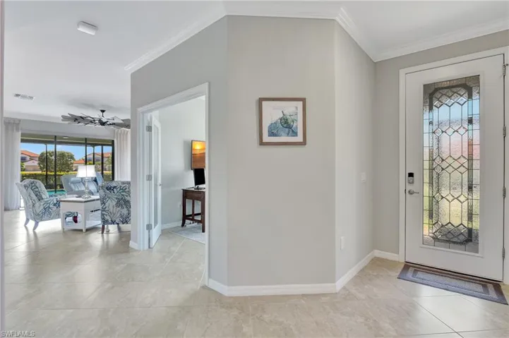 Glass front door with nice welcoming foyer