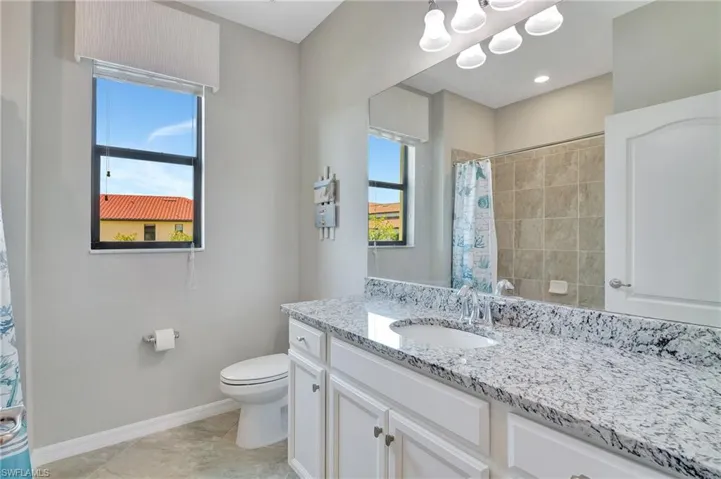 Tub/shower with granite counter & single sink