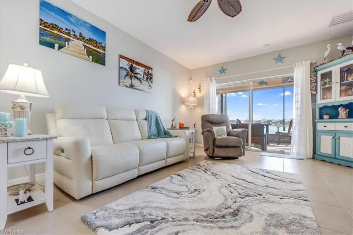 Open living space with ceiling fan and natural light from glass sliders