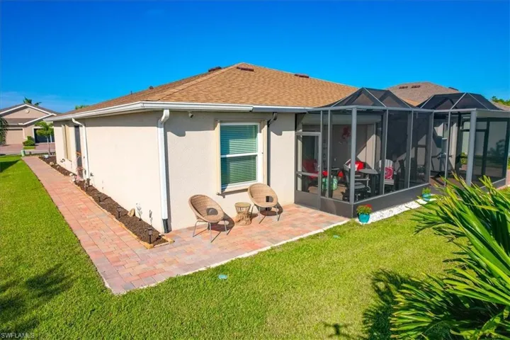 Back of house with extended screened and unscreened patio.