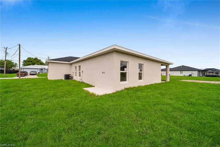 View of property exterior with a patio area, a yard, and central air condition unit