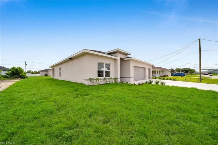 View of side of home featuring a lawn