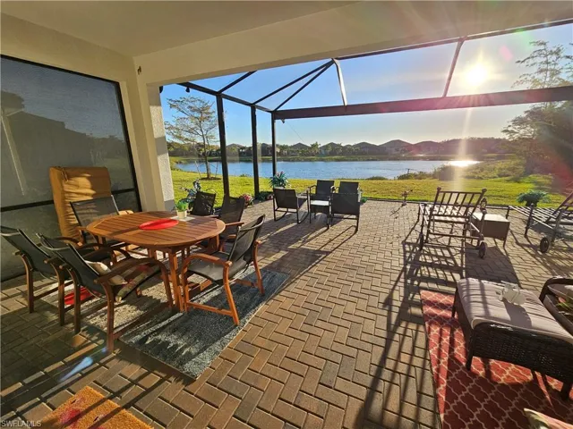 Sunroom featuring a water view