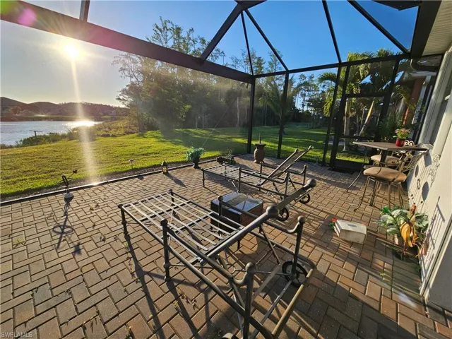 sunroom featuring a water view