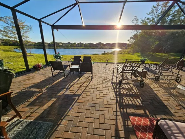 Sunroom / solarium featuring a water view