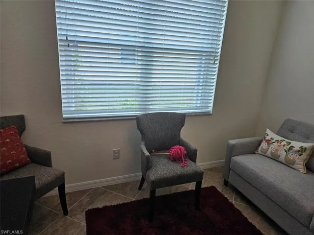 Living area featuring tile patterned flooring and a wealth of natural light