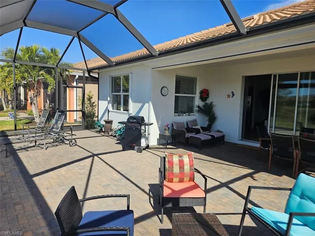 View of patio featuring area for grilling, a lanai, and outdoor lounge area
