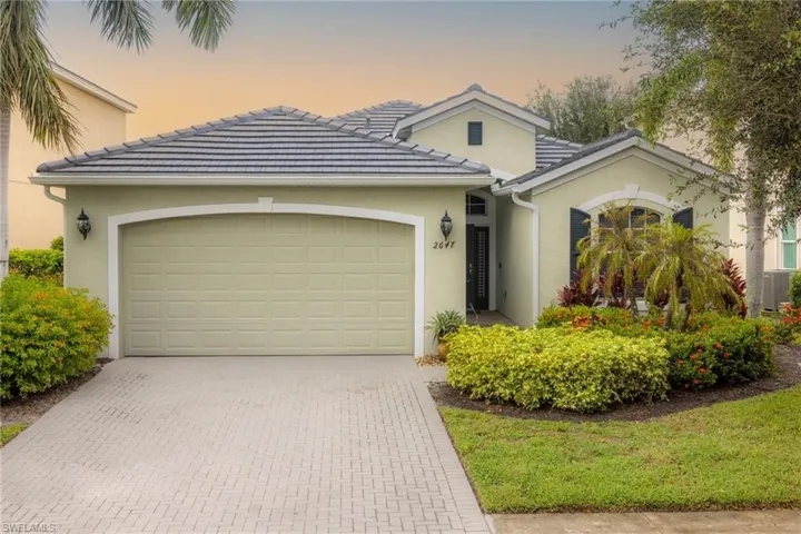 View of front of property featuring central AC and a garage
