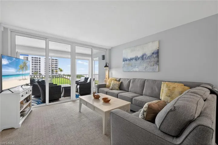 Living room featuring expansive views of the Gulf of Mexico. - Virtually Edited Image