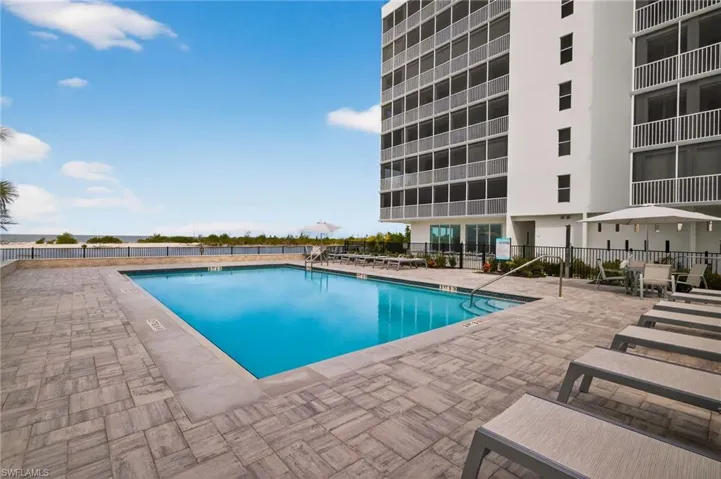 Community pool with fantastic views and plenty of room for relaxing. - Virtually Edited Image
