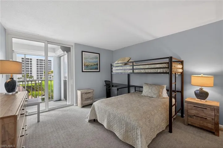 Guest bedroom featuring lanai access and floor to ceiling windows. - Virtually Edited Image