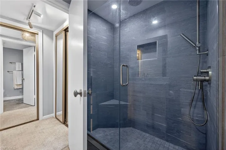 Bathroom featuring a walk in shower with hand held shower wand. - Virtually Edited Image