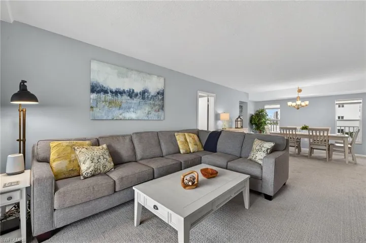 Great room with separate living and dining areas perfect for entertaining. - Virtually Edited Image
