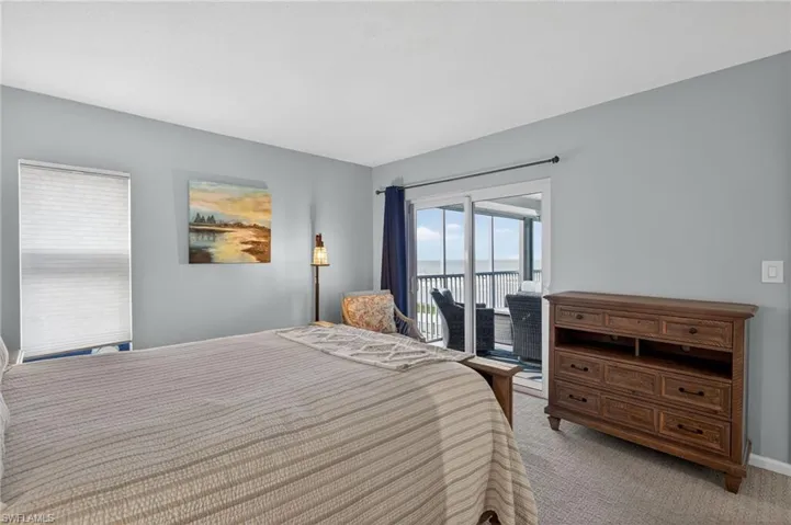 Another view of bedroom highlighting access to the lanai, and a water view - Virtually Edited Image