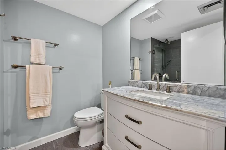 Bathroom featuring large vanity and stall shower. - Virtually Edited Image