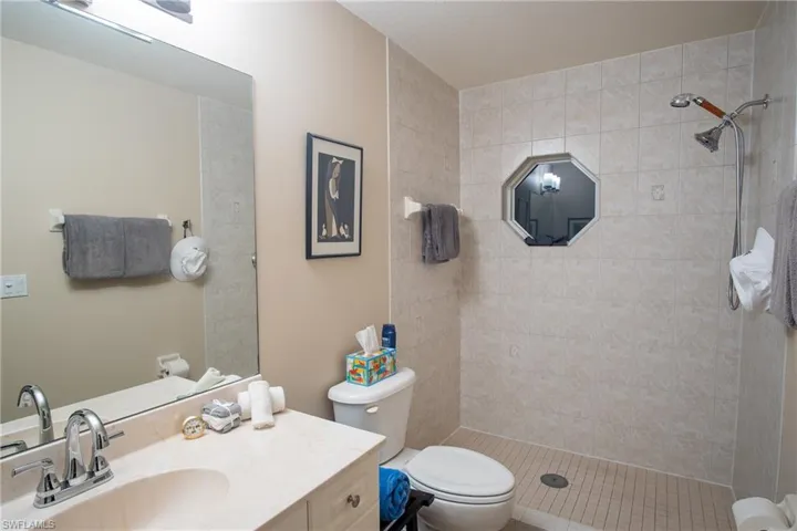 Front Cabana Bathroom with tiled shower, vanity, and toilet