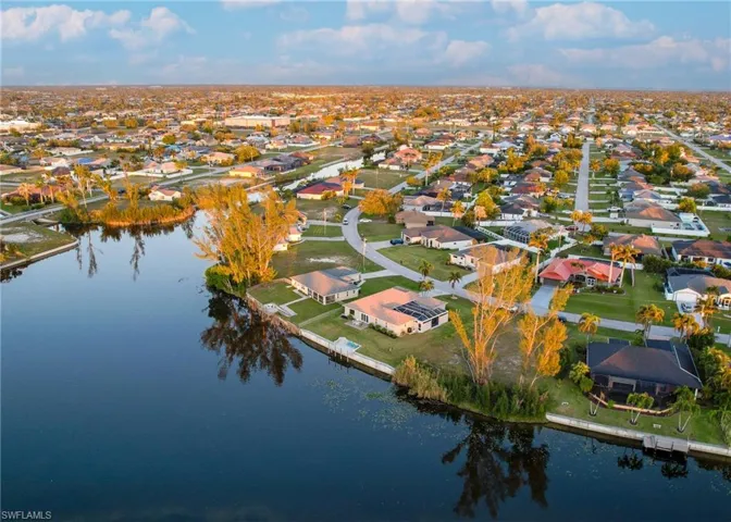 Birds eye view of property with a water view