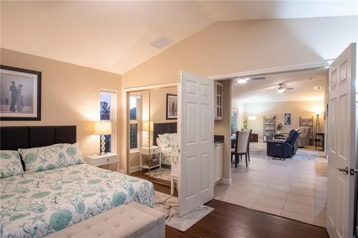 Bedroom with lofted ceiling, wood-type flooring, and a closet