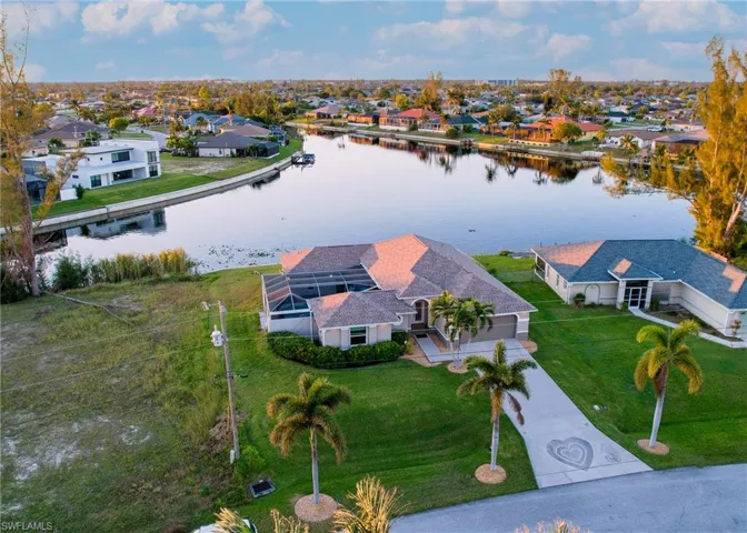 Birds eye view of property with a water view