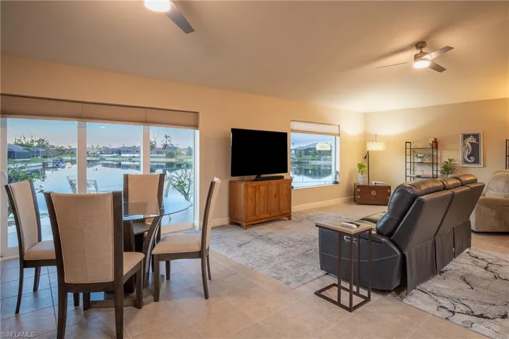 Tiled living room featuring ceiling fan and a healthy amount of sunlight