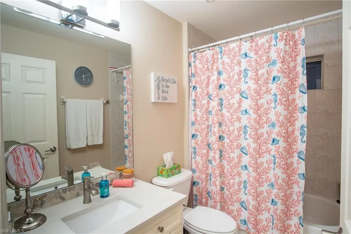 Bathroom with vanity, toilet, and walk in shower