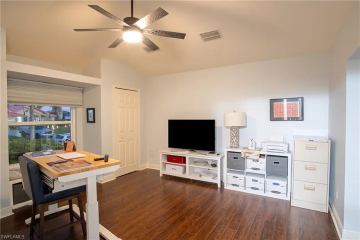 Front Cabana Bedroom featuring ceiling fan, lofted ceiling, and dark wood-type flooring
