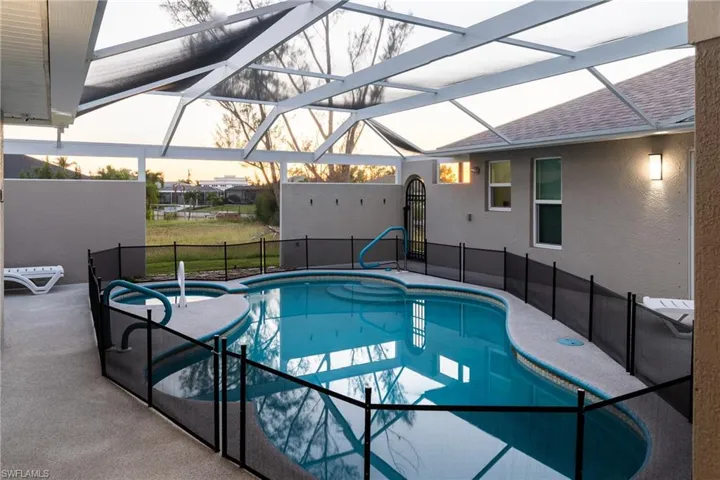 View of swimming pool featuring a patio and a lanai
