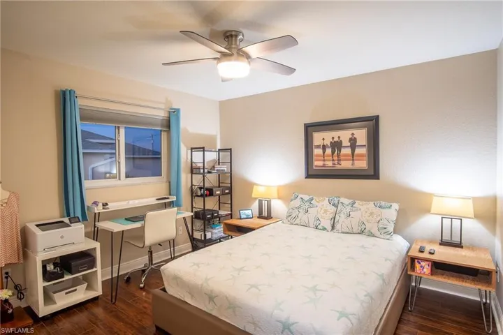 Bedroom with ceiling fan and dark hardwood / wood-style flooring