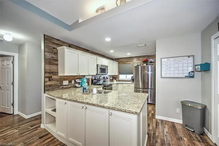 Newer kitchen with wood cabinets and granite counter tops.