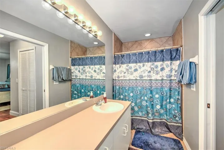 Very large counter top with a single sink and a large shower.