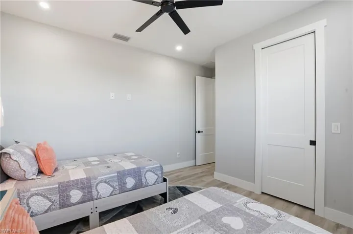 Bedroom with light wood-style flooring, recessed lighting, and a ceiling fan