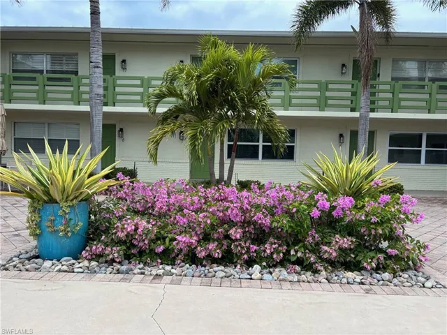 View of front of property featuring stucco siding and brick siding