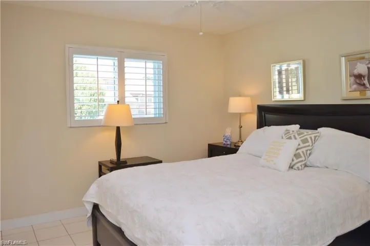 Bedroom featuring baseboards and tile patterned floors