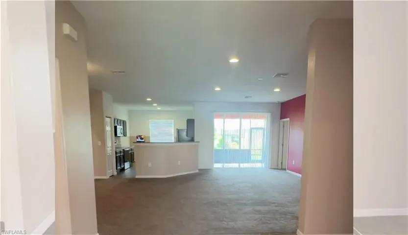 Unfurnished living room featuring carpet flooring and recessed lighting