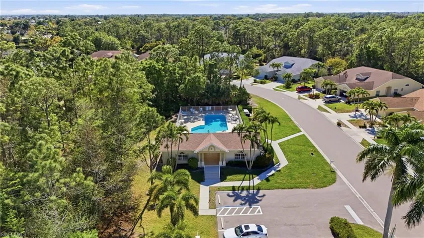 Drone / aerial view of a pool and a forest