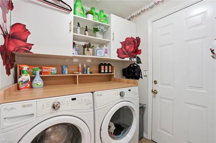 Laundry room featuring washer and dryer and cabinet space