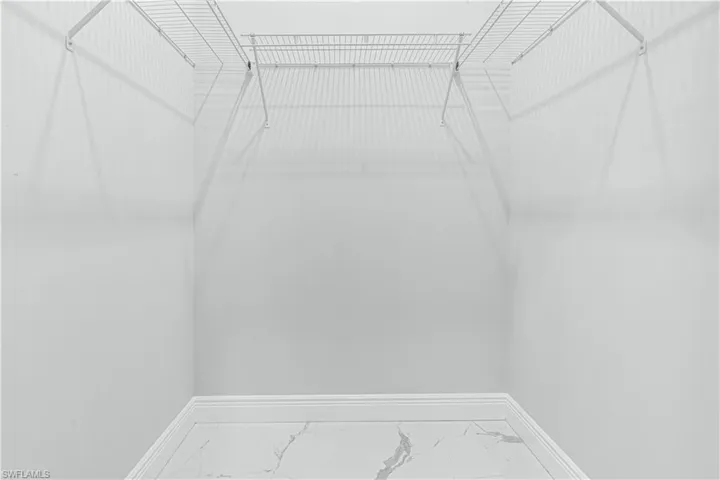 Master bedroom Walk-in closet with tile flooring