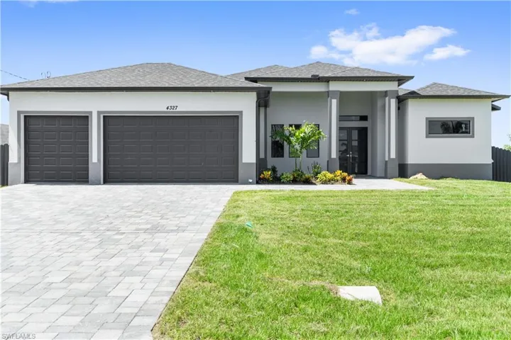 Modern, Brand New home with a front yard and a garage
