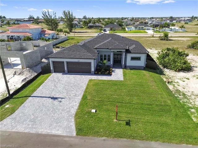 View of front of home featuring a front lawn and a garage