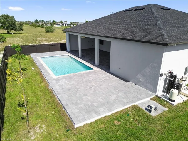 View of pool featuring a patio and a lawn