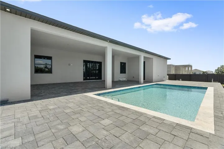 View of swimming pool with a large patio area