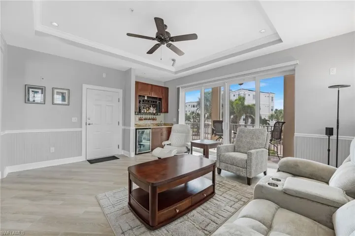 Your second living area features a wet bar complete with a sink, refrigerator, glass rack, and ample storage. Beautiful tray ceiling.