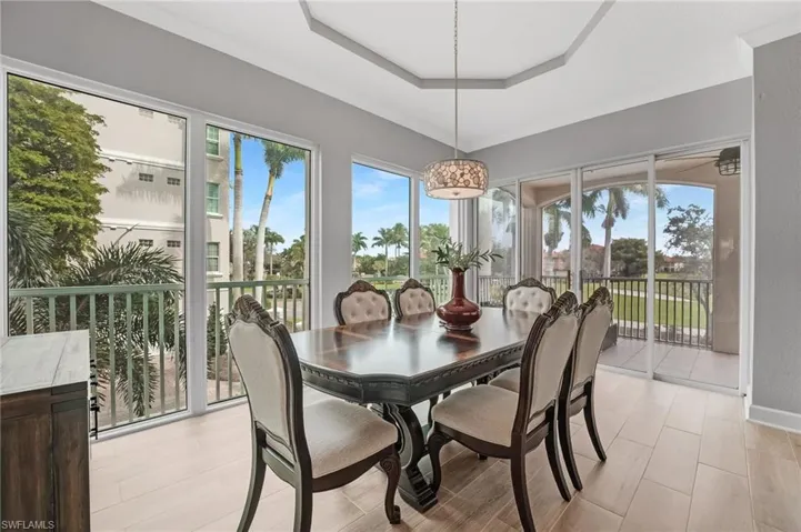 From your formal dining area, picture windows and sliding glass doors flood the space with natural light while framing sweeping views of the golf course and lake.