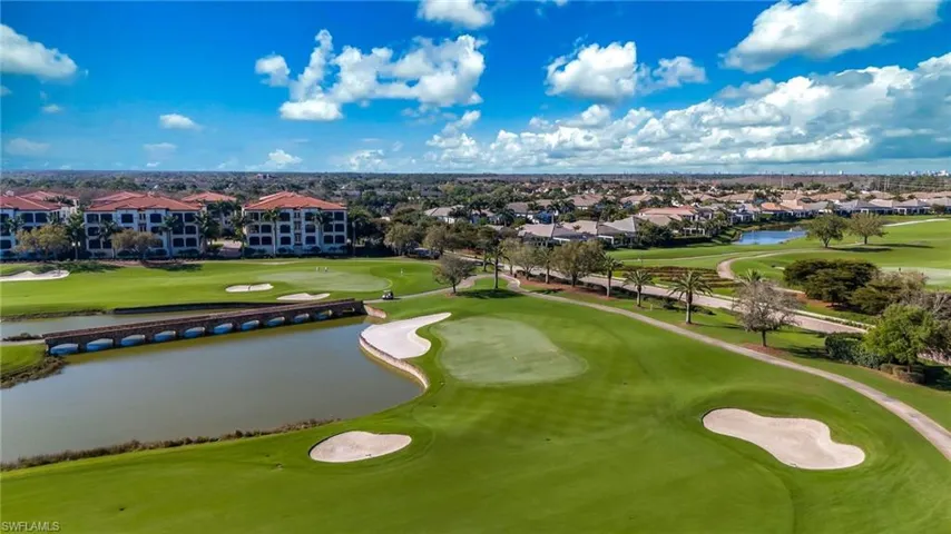 Aerial perspective of suburban area with a golf club and a nearby body of water