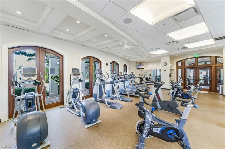 Workout area with french doors, coffered ceiling, and recessed lighting