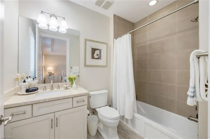 Full bath featuring vanity, shower / bathtub combination with curtain, and connected bathroom