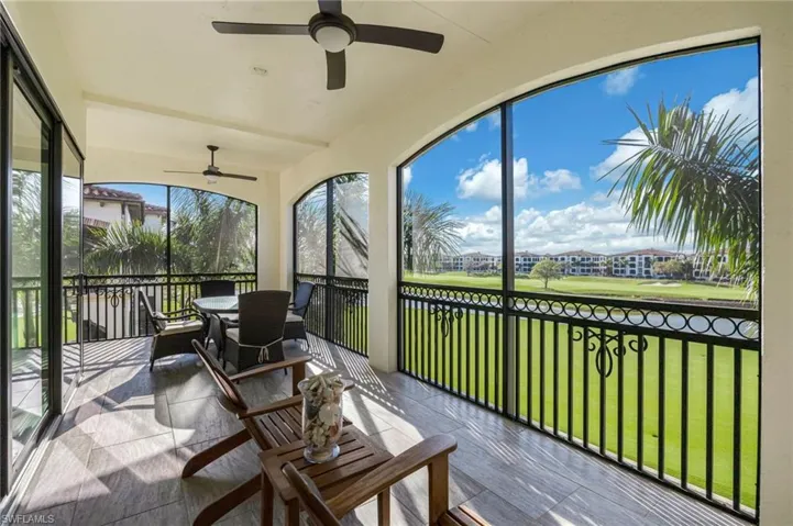 Sunroom featuring ceiling fan and view of golf course