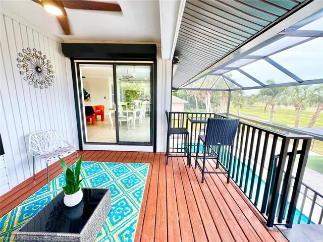 Wooden deck featuring a lanai and a sunroom